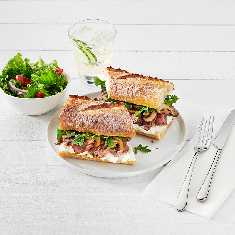 Made with our handcrafted sourdough starters and baked on stone, delivering a crisp crust, chewy, open crumb, and signature mild sourness. Its consistent size is versatile to accommodate 6”, 9”, or 12” sandwiches. Elevate your menu experience with an authentic artisan sourdough baguette. Try it as a Steak and Burrata Sandwich.