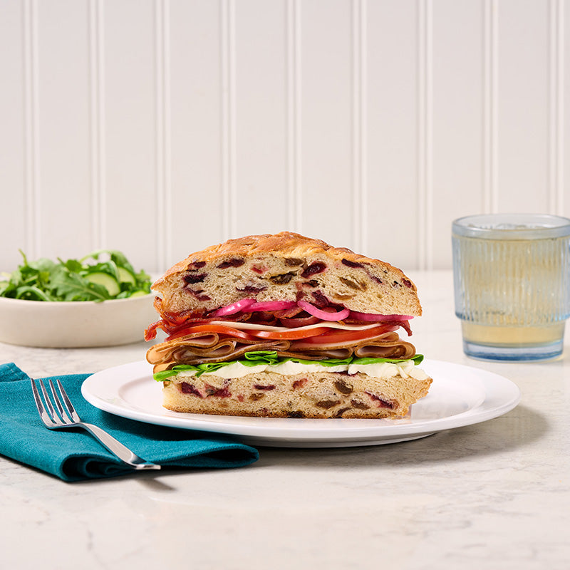 Rich focaccia filled with cranberries and raisins. The crisp, golden crust is dusted with turbinado sugar. 7.75" x 5.75". Serve as a Cranberry Focaccia French Toast Tartine!