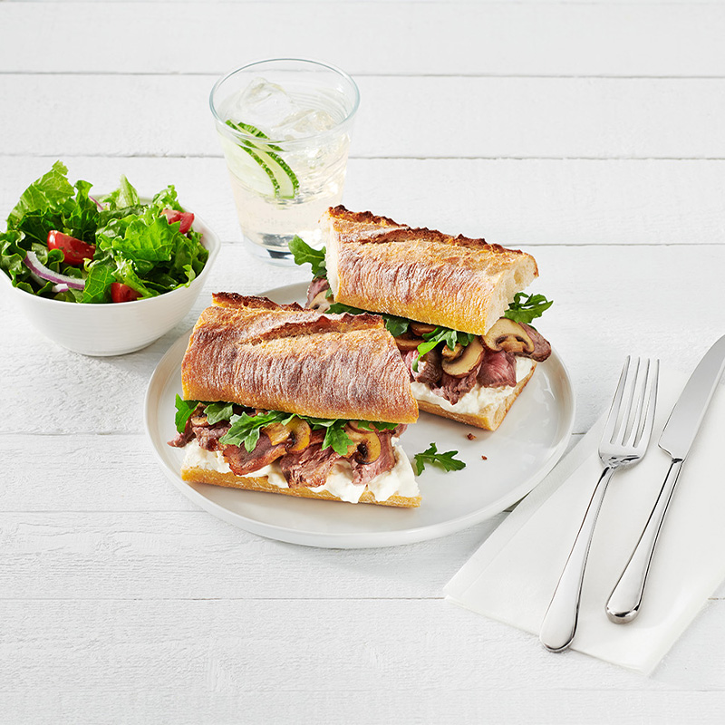 ACE Bakery® Foodservice Sourdough Baguette served as steak and burrata cheese sandwich with a side salad as an elevated main dish.